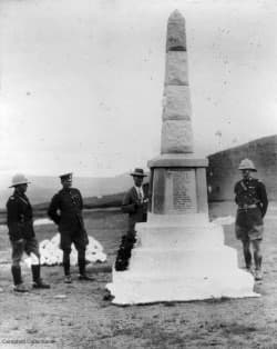 A group of men standing next to a monument AI-generated content may be incorrect.
