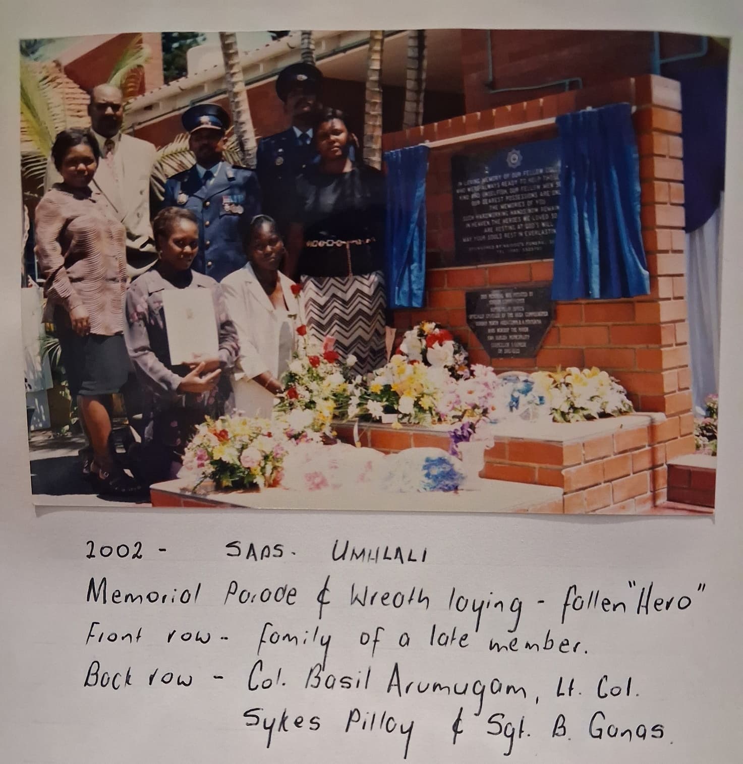 A group of people standing in front of a memorial AI-generated content may be incorrect.